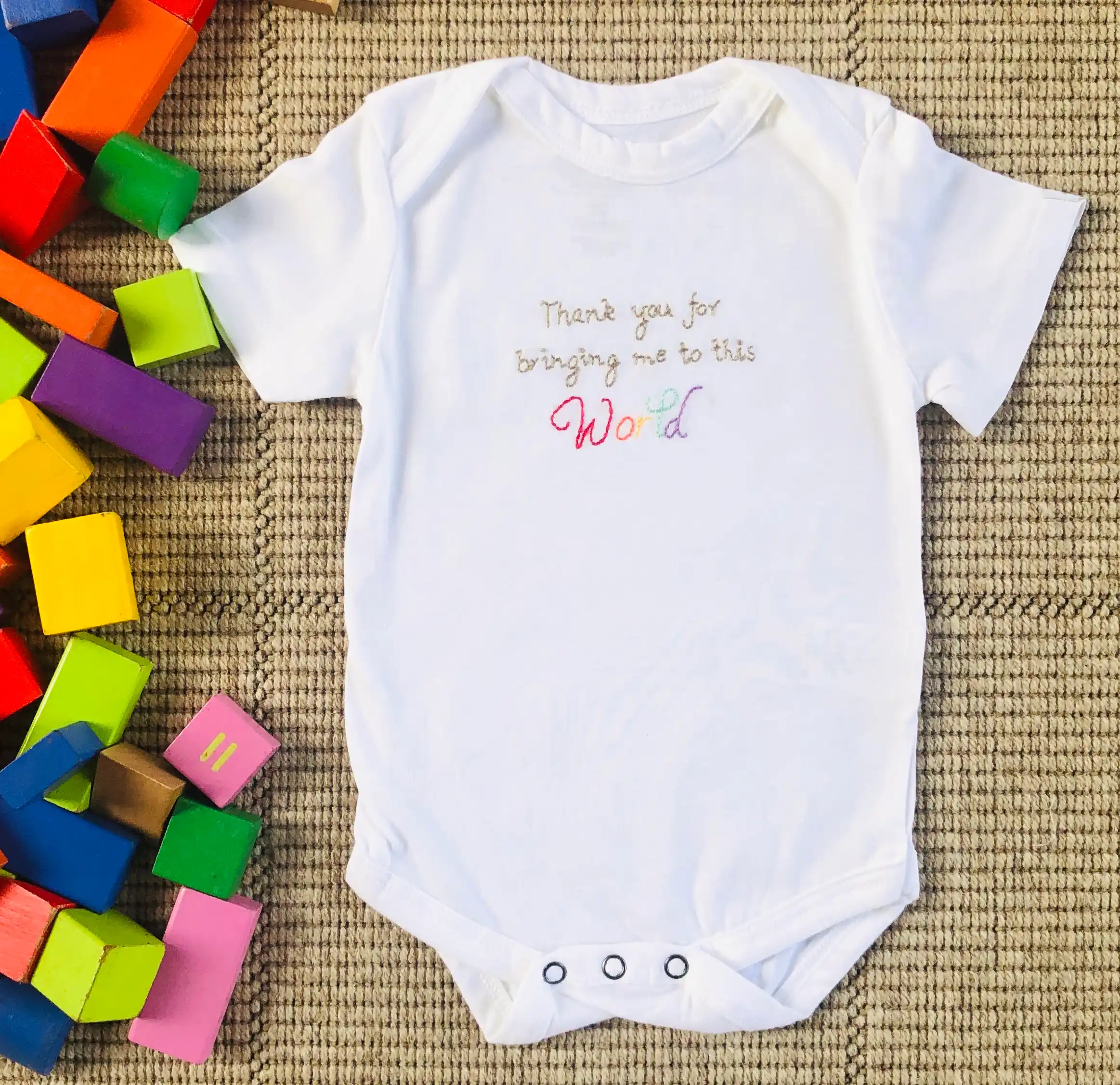 Handembroideredbabyonesie-world